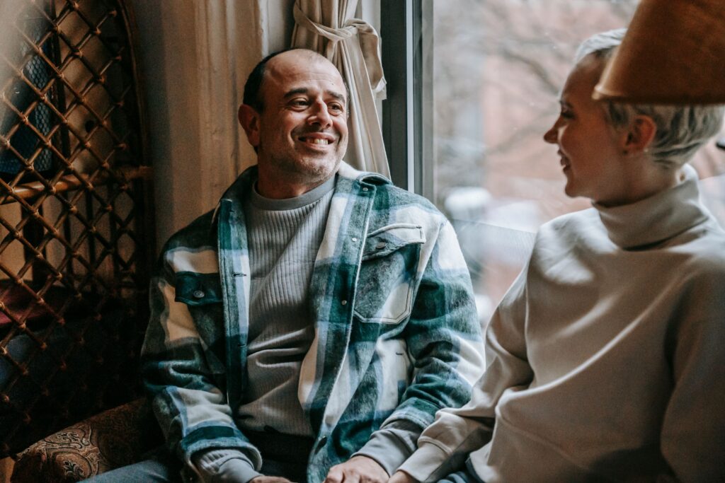 Happy couple talking and smiling home