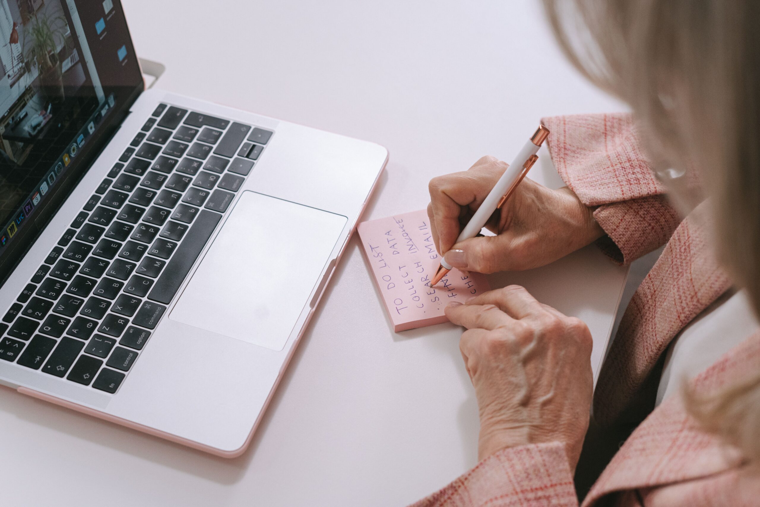 Older adult writing to-do list manage stress home